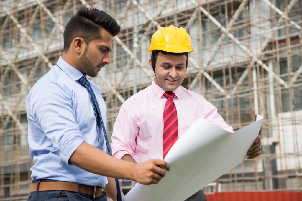 An Engineer showing Map to a young boy